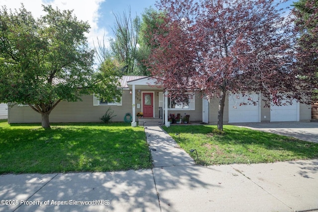 750 Breeze St, Craig, CO 81625 - obstructed view of property featuring a garage, driveway, a front yard, and a metal roof