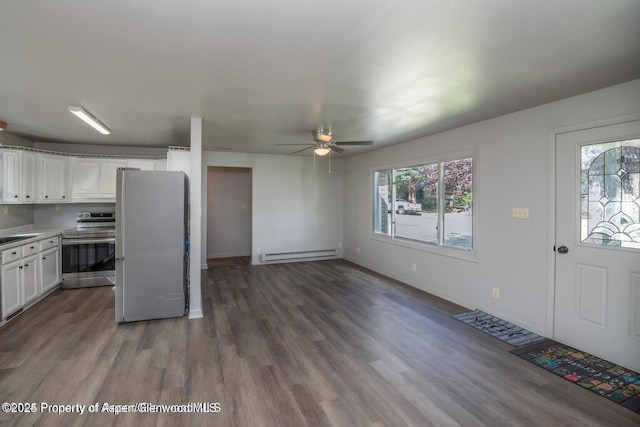 750 Breeze St, Craig, CO 81625 - kitchen with stainless steel appliances, a baseboard radiator, white cabinets, and wood finished floors