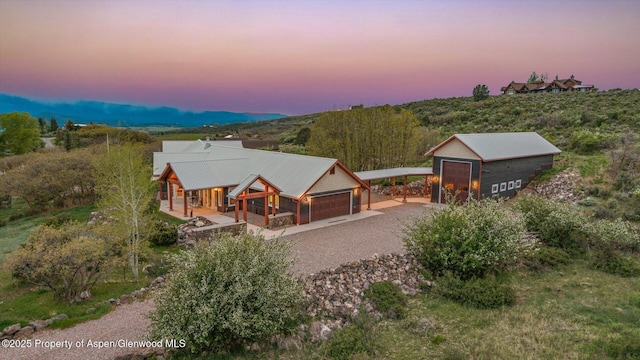 220 Sam Grange Ct, Eljebel, CO 81623 - rustic home with a garage, driveway, a porch, and metal roof