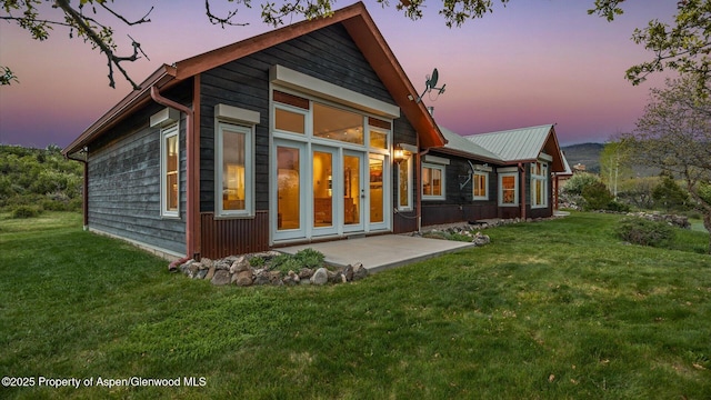 220 Sam Grange Ct, Eljebel, CO 81623 - back of house at dusk with a yard and a patio
