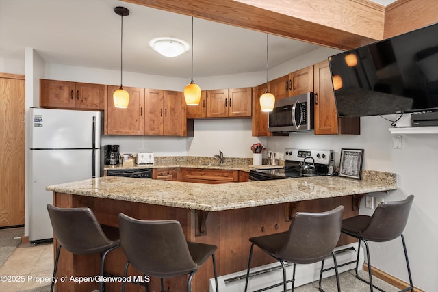 kitchen featuring kitchen peninsula, a breakfast bar, stainless steel appliances, and a baseboard radiator