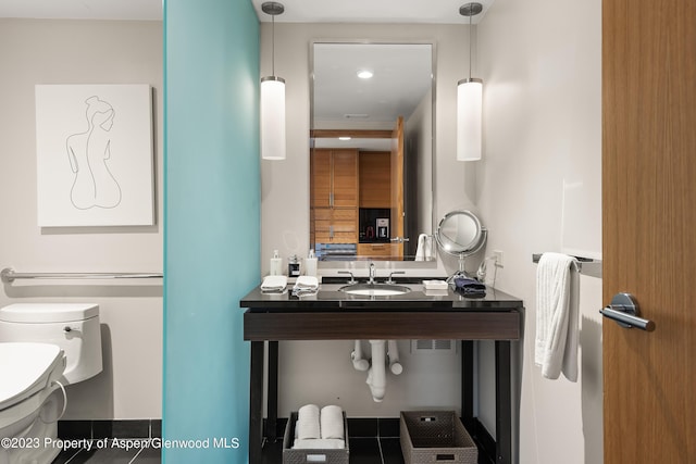 bathroom with tile patterned flooring, toilet, and sink