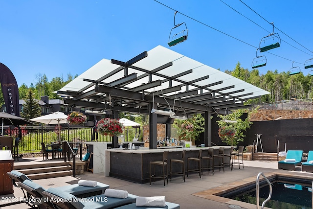 view of patio / terrace featuring a pergola and an outdoor bar