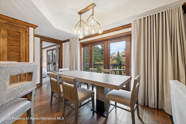 dining room with a chandelier, french doors, and dark wood finished floors