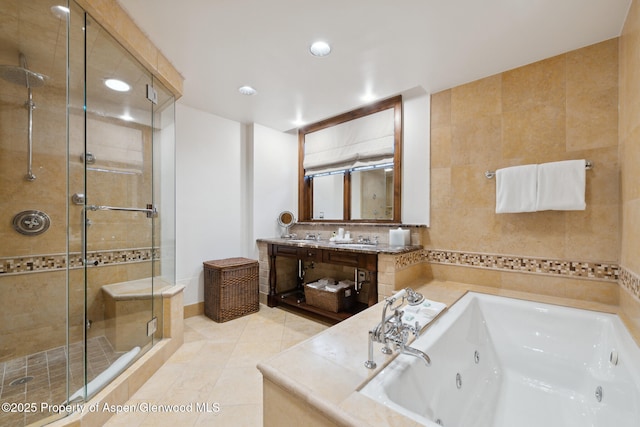 bathroom featuring tile patterned flooring, recessed lighting, vanity, a jetted tub, and a shower stall