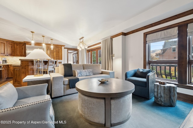 living room featuring lofted ceiling and an inviting chandelier