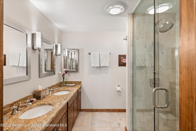 926 Waters Ave # 203, Aspen, CO 81611 - full bathroom with double vanity, a stall shower, and baseboards