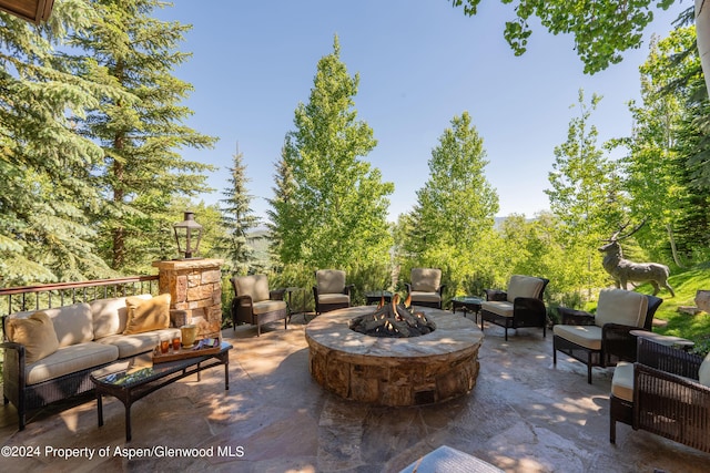 view of patio / terrace with an outdoor living space with a fire pit