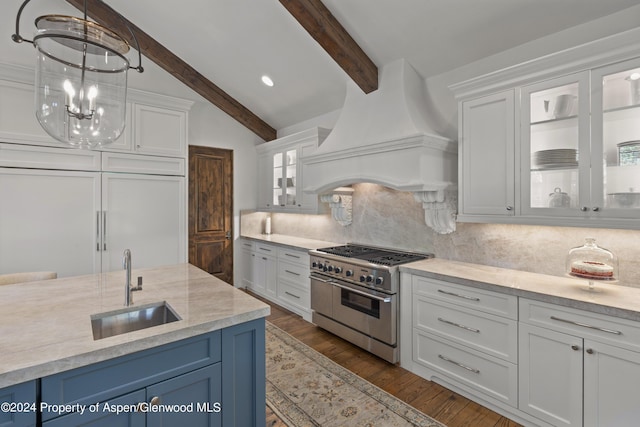 kitchen featuring blue cabinetry, premium range hood, white cabinets, and high end appliances