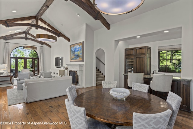 dining space with vaulted ceiling with beams and dark hardwood / wood-style flooring