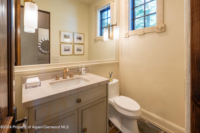 bathroom featuring vanity and toilet