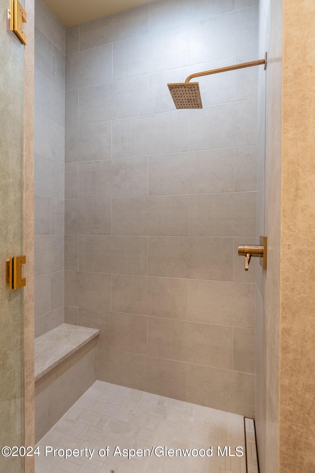 bathroom with a shower with door