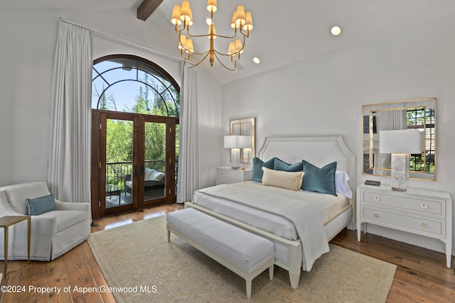 bedroom featuring lofted ceiling with beams, access to exterior, dark wood-type flooring, and multiple windows