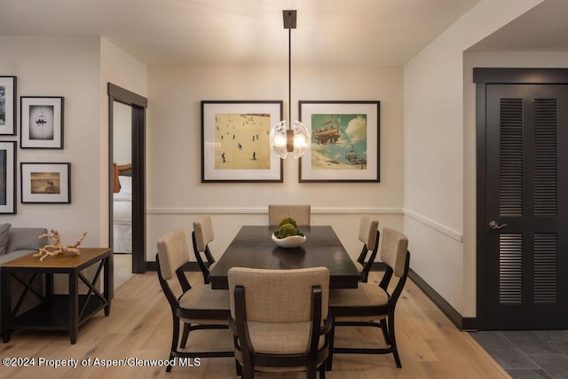 dining room with light hardwood / wood-style flooring and a chandelier