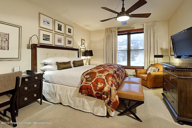 bedroom featuring light colored carpet and ceiling fan