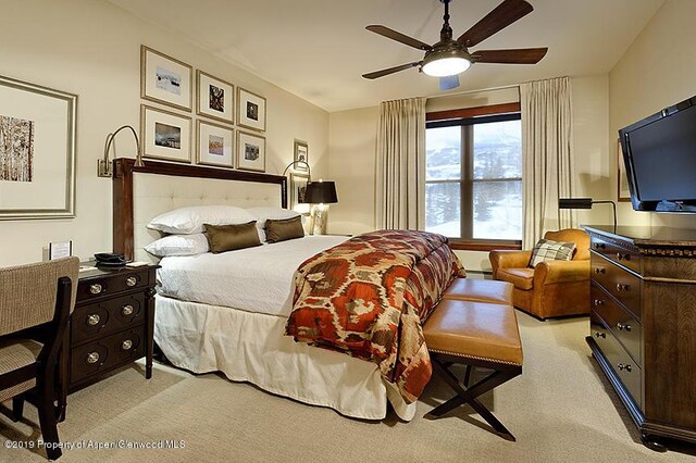 bedroom featuring light colored carpet and ceiling fan