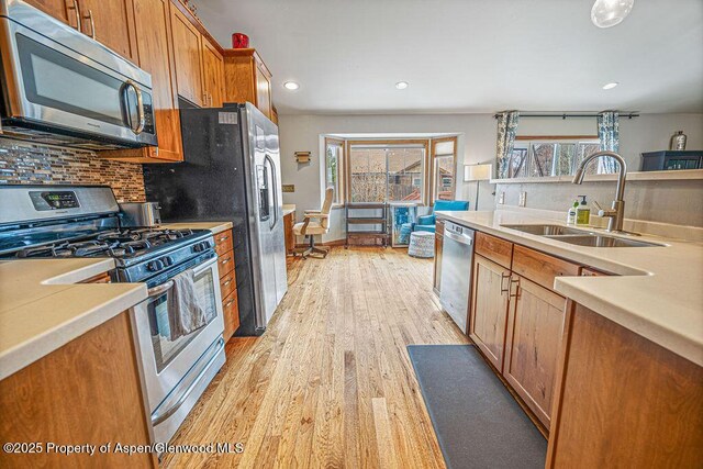 352 Lake View Rd, Hayden, CO 81639 - kitchen with appliances with stainless steel finishes, a sink, recessed lighting, decorative backsplash, and light wood-style floors