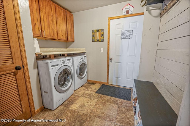 352 Lake View Rd, Hayden, CO 81639 - laundry area with washing machine and dryer, light stone finish flooring, cabinet space, and baseboards