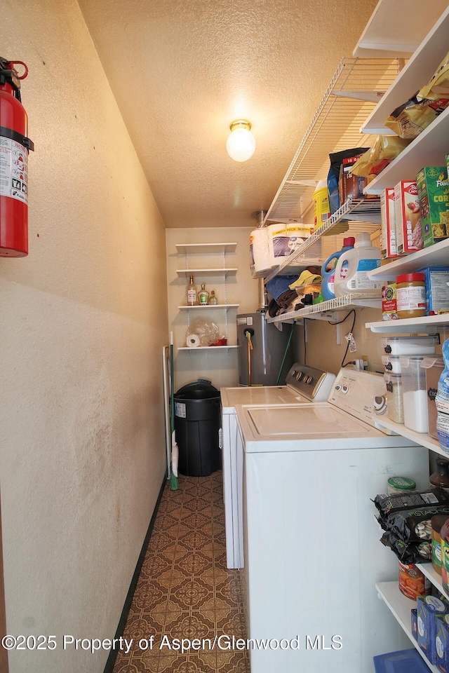 2340 Ute Ave, Rifle, CO 81650 - washroom featuring separate washer and dryer, water heater, a textured wall, a textured ceiling, and tile patterned floors