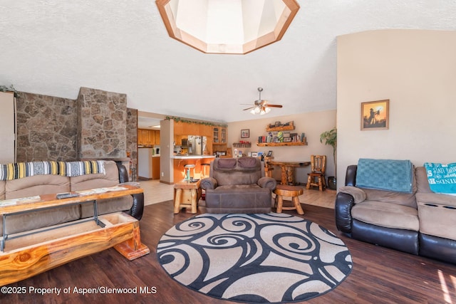 565 Sandrock Dr, Craig, CO 81625 - living room with wood finished floors, vaulted ceiling, ceiling fan, and a textured ceiling