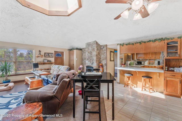565 Sandrock Dr, Craig, CO 81625 - living area featuring a textured ceiling, a ceiling fan, and light tile patterned flooring