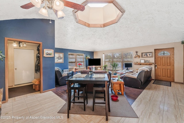 565 Sandrock Dr, Craig, CO 81625 - dining area featuring a textured ceiling, ceiling fan, vaulted ceiling, and baseboards