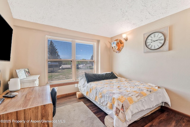 565 Sandrock Dr, Craig, CO 81625 - bedroom featuring a textured ceiling, dark wood-type flooring, and baseboards