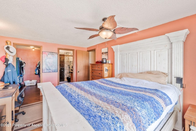 565 Sandrock Dr, Craig, CO 81625 - bedroom with a spacious closet, a closet, a textured ceiling, ceiling fan, and ensuite bath