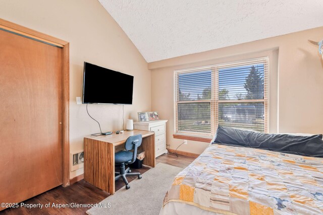 565 Sandrock Dr, Craig, CO 81625 - bedroom featuring lofted ceiling, wood finished floors, baseboards, a textured ceiling, and a desk
