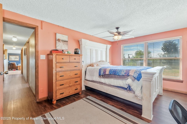 565 Sandrock Dr, Craig, CO 81625 - bedroom featuring a textured ceiling, wood finished floors, baseboards, and a ceiling fan