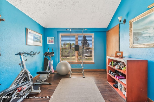 565 Sandrock Dr, Craig, CO 81625 - exercise room with wood finished floors, a textured ceiling, a textured wall, and baseboards