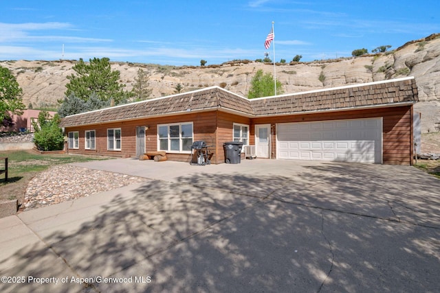 565 Sandrock Dr, Craig, CO 81625 - view of front of property featuring driveway, an attached garage, and a mountain view
