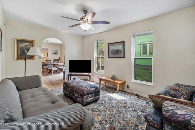 824 Lincoln Ave, Glenwood Springs, CO 81601 - living area featuring baseboards, a ceiling fan, wood finished floors, and arched walkways