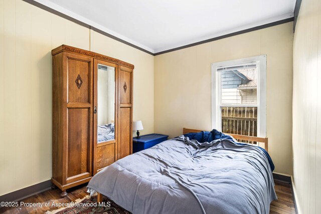 824 Lincoln Ave, Glenwood Springs, CO 81601 - bedroom featuring baseboards, ornamental molding, and dark wood-type flooring