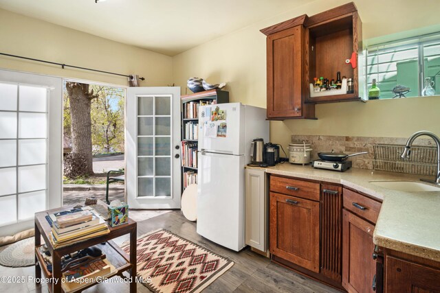 824 Lincoln Ave, Glenwood Springs, CO 81601 - kitchen with light countertops, freestanding refrigerator, a healthy amount of sunlight, and a sink