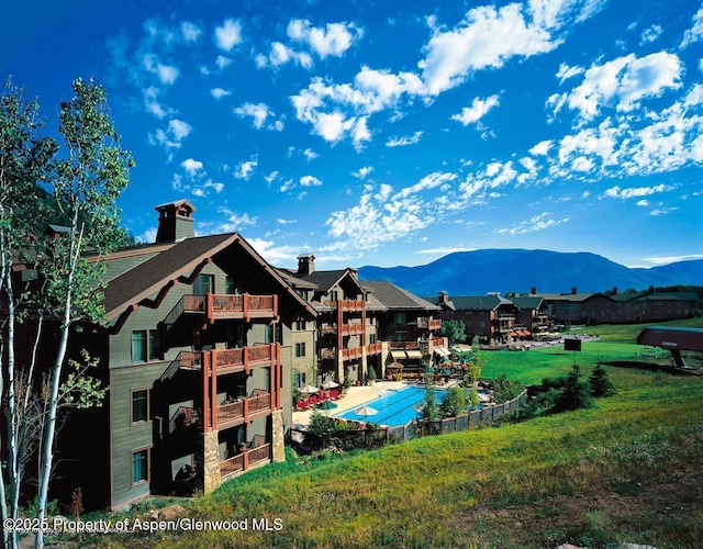 exterior space with a mountain view and a lawn