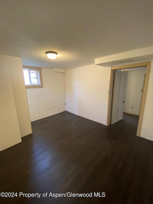 unfurnished room with dark hardwood / wood-style floors