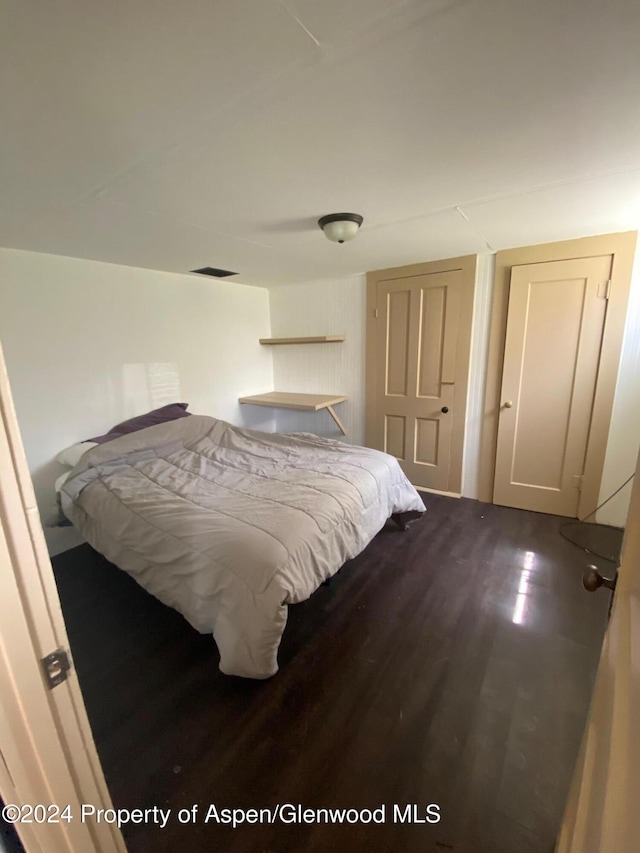 bedroom with wood-type flooring