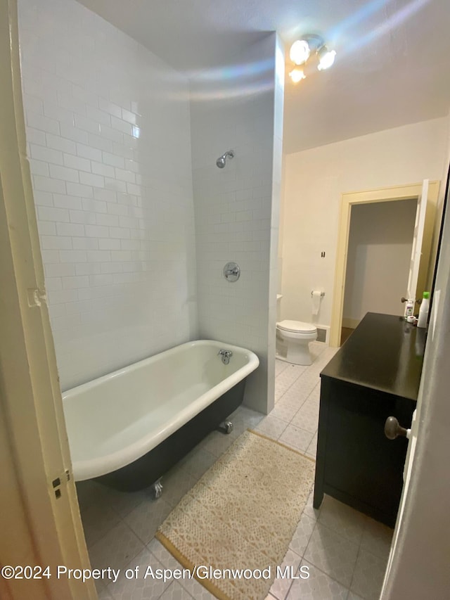 bathroom featuring a tub, tile patterned flooring, and toilet