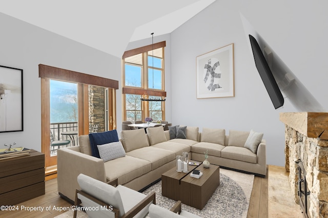 living room featuring light hardwood / wood-style flooring and a high ceiling