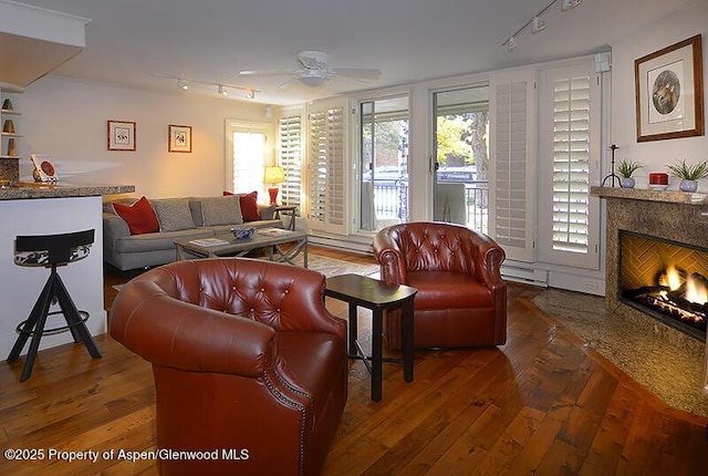 800 E Hopkins Ave Unit A-1, Aspen, CO 81611 - living room with track lighting, a premium fireplace, a ceiling fan, and healthy amount of natural light