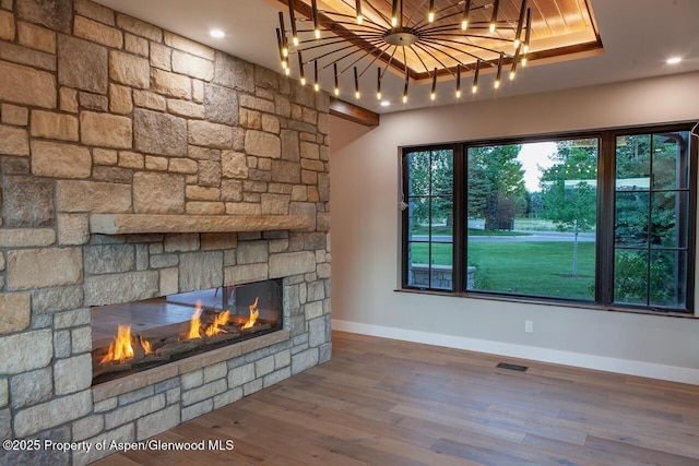 115 Sundance Trl, Carbondale, CO 81623 - unfurnished living room featuring a fireplace, wood finished floors, and a raised ceiling