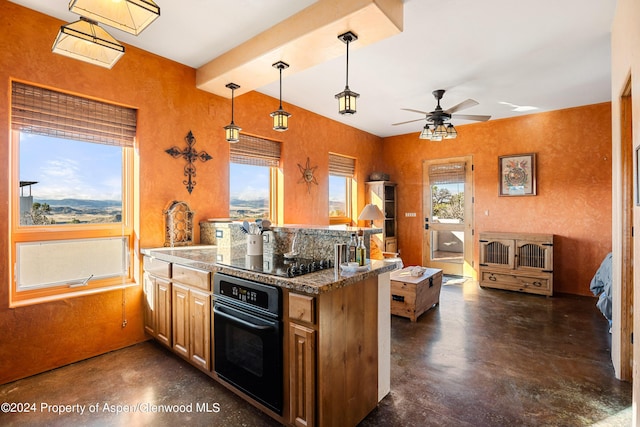 kitchen with kitchen peninsula, a wealth of natural light, ceiling fan, black appliances, and hanging light fixtures