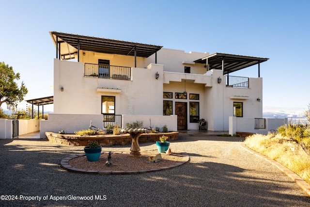 rear view of property featuring a balcony