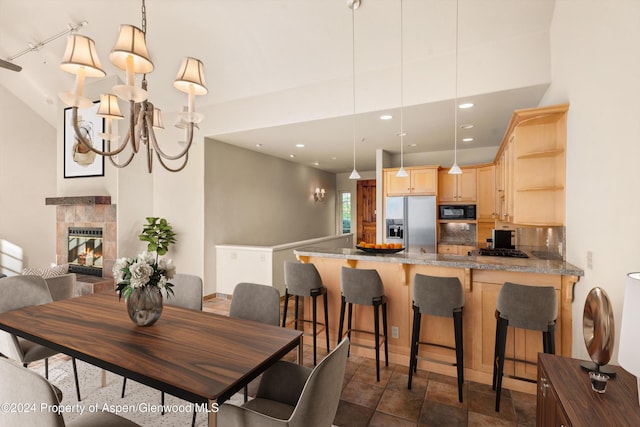 dining room featuring a fireplace and a chandelier