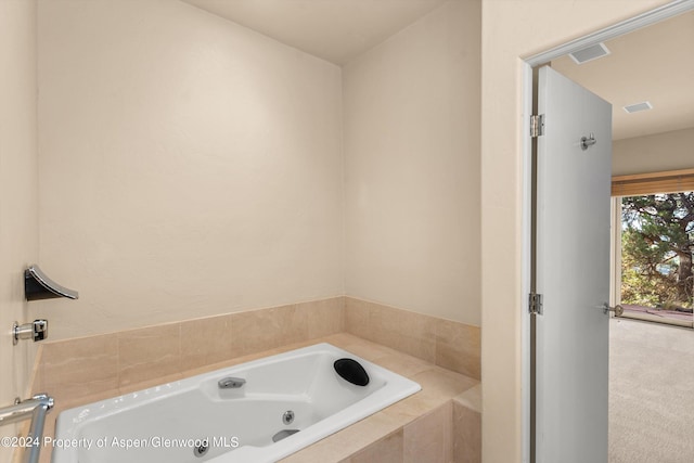 bathroom featuring tiled tub