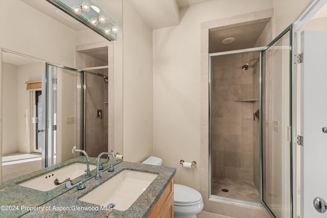 bathroom with vanity, toilet, and a shower with shower door