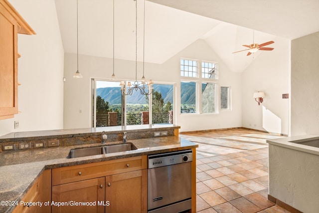 kitchen featuring stainless steel dishwasher, ceiling fan with notable chandelier, sink, pendant lighting, and high vaulted ceiling