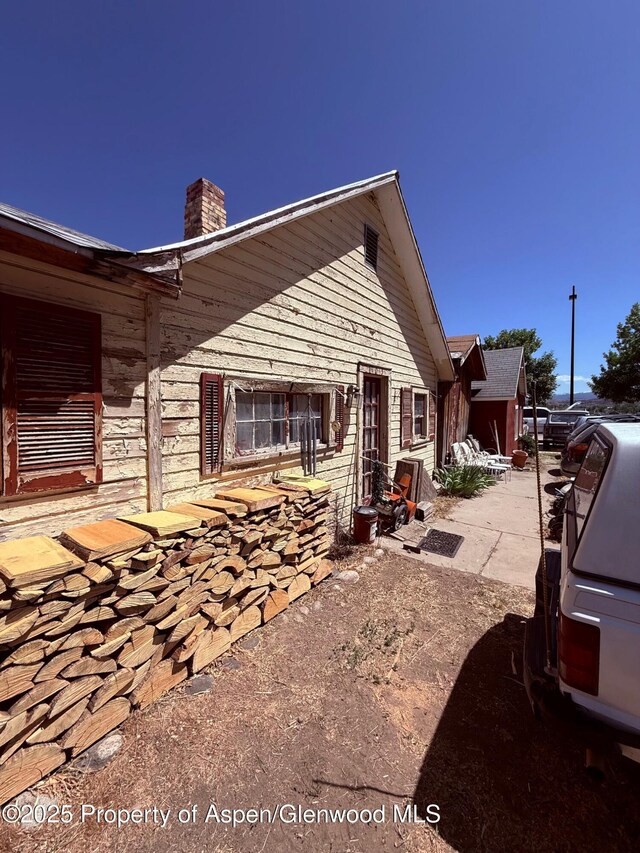 110 N 5th St, Silt, CO 81652 - view of property exterior featuring a chimney