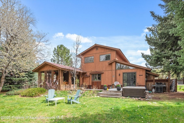 back of property with a yard and central air condition unit